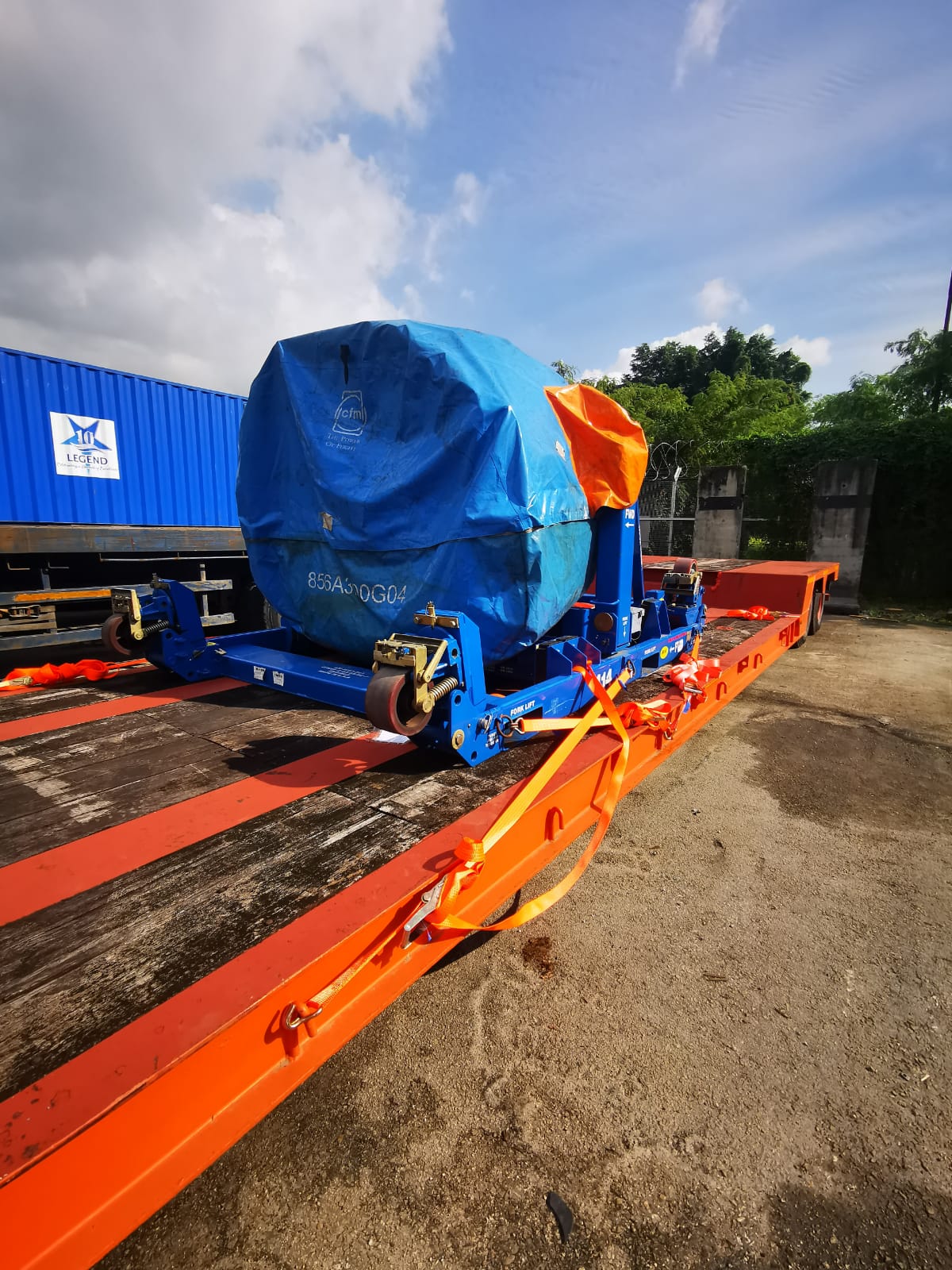 Home Infabest Logistics heavy machinery secured for transport on flatbed
